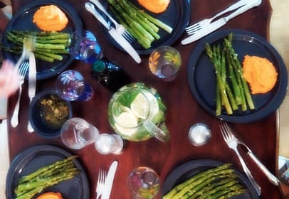 several servings of the blogpost recipe on blue/grey plates on a dark brwon table with cutlery in silver